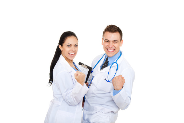 Sonriente equipo médico y sosteniendo el puño sí
 - Foto, Imagen