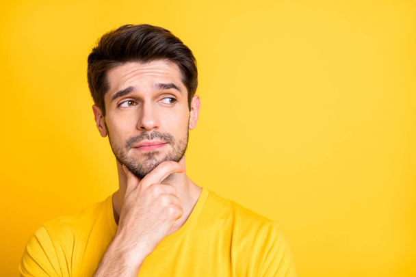 Close-up portrait of his he nice attractive lovely doubtful brown-haired guy thinking touching chin creating new idea isolated over bright vivid shine vibrant yellow color background - Фото, зображення