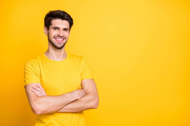 Portrait of his he nice attractive lovely cheerful cheery content brown-haired guy wearing tshirt folded arms isolated over bright vivid shine vibrant yellow color background - Фото, зображення