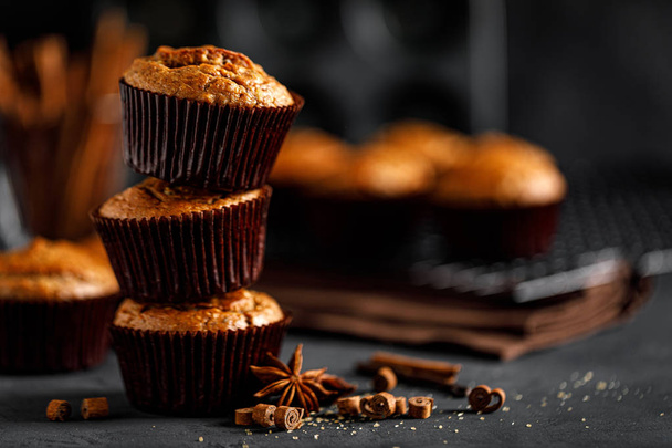 Cinnamon muffins on black background - Foto, Imagen