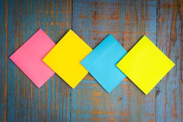 Minimalist flat lay composition of sticky notes on the wooden table top view. Copy space concept - Photo, Image