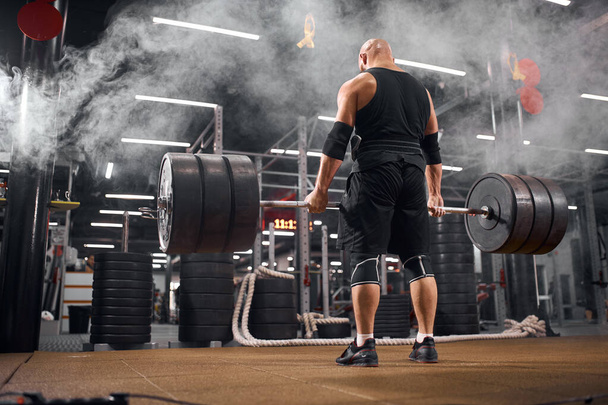 Active powerlifter in white smoke - Photo, Image