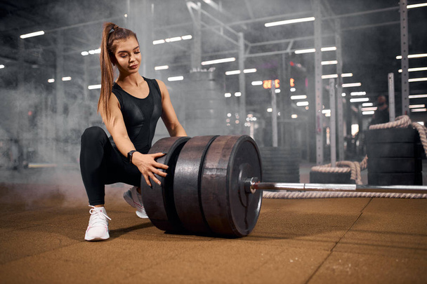 Charming female with heavy barbell - Photo, Image