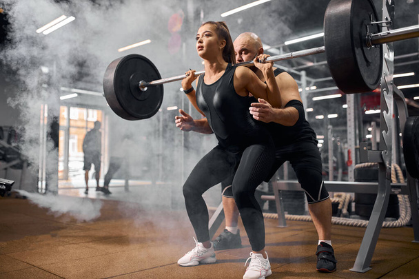 Active couple training in gym hall - Фото, изображение