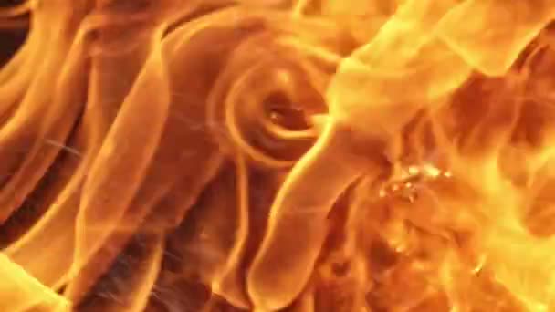 Dense fire background with playing forks and tongues outdoors in summer.              Magnificent background closeup of thick red, yellow, and orange flame dancing mysteriously outdoors in summer. it looks mesmerizing, dangerous and fine. - Footage, Video