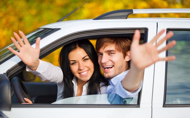 Young happy couple driving in car - 写真・画像