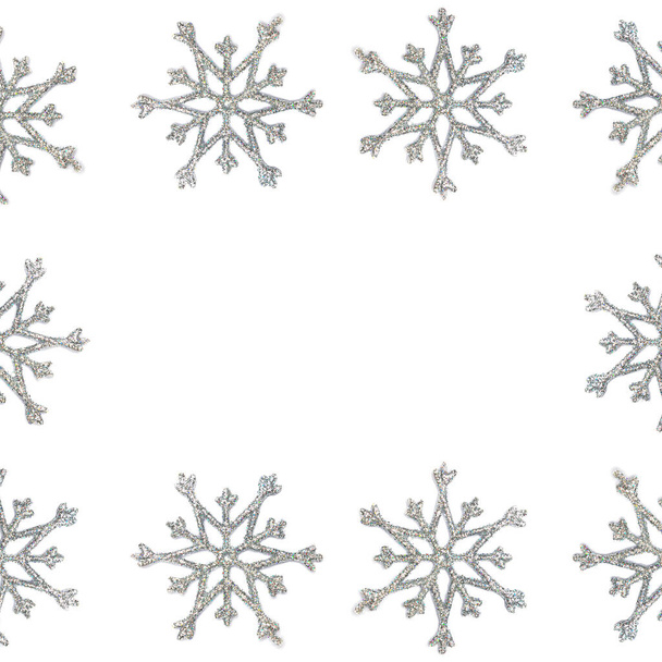Christmas snowflake border frame background. Silver snowflake top view isolated on white background - Photo, Image
