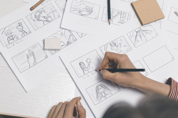 An animator artist draws storyboards. - Valokuva, kuva