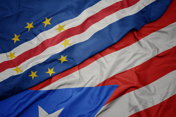 хвилястий барвистий прапор Пуерто-Рико і національний прапор мису Верде
. - Фото, зображення