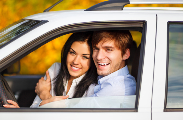 Young smile couple driving car - Фото, изображение