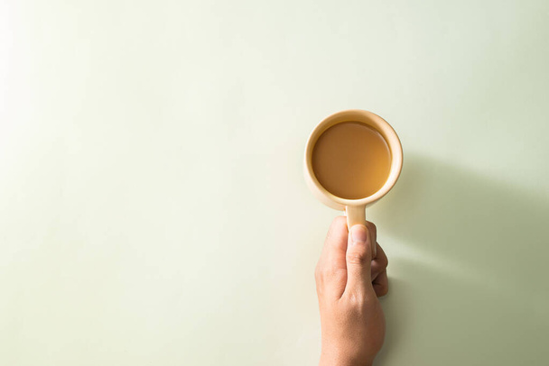 Hand holding the cup of coffee on background  - Photo, image