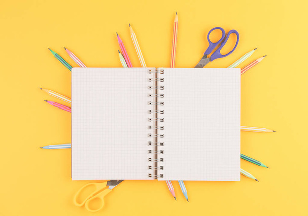notebook on a yellow isolated background, office supplies - 写真・画像