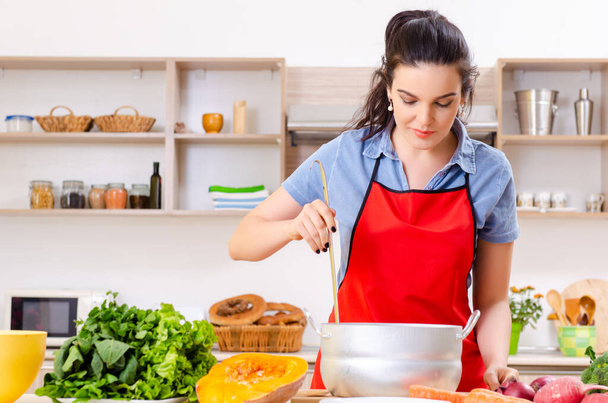Young woman with vegetables in the kitchen - Photo, Image