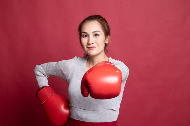 Young Asian woman with red boxing gloves. - Фото, изображение