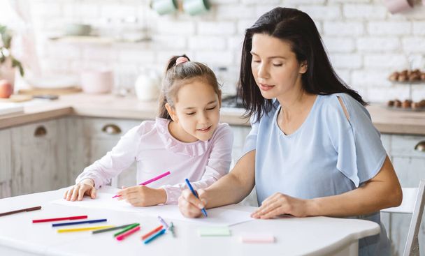 Maman enseigne à sa petite fille comment dessiner
 - Photo, image