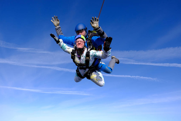 Skydiving. Tandem jump. People in the sky. A man and a woman are flying together. - Photo, Image