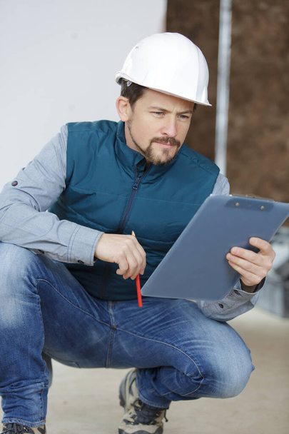 a builder in with clipboard - Photo, Image