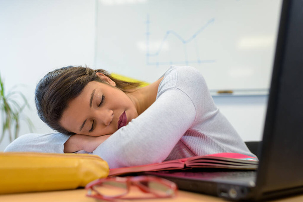 young woman asleep at desk - Photo, Image