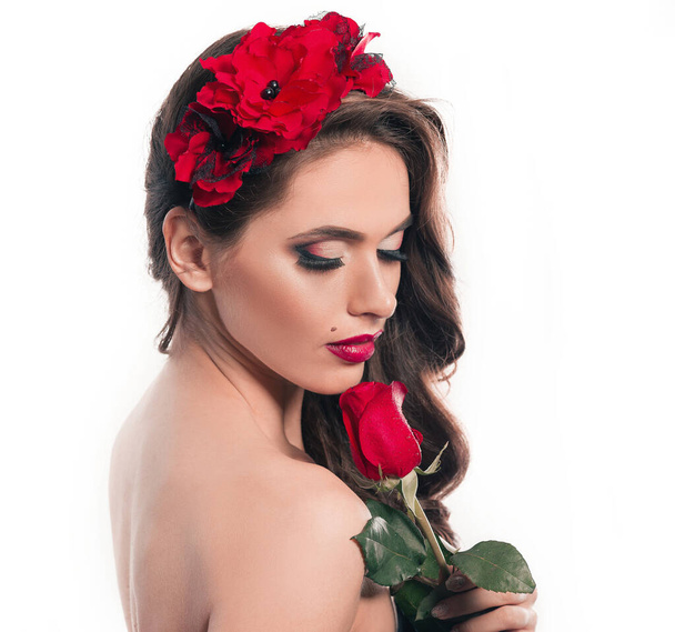 side view.beautiful woman looking at rose in her hands - Φωτογραφία, εικόνα