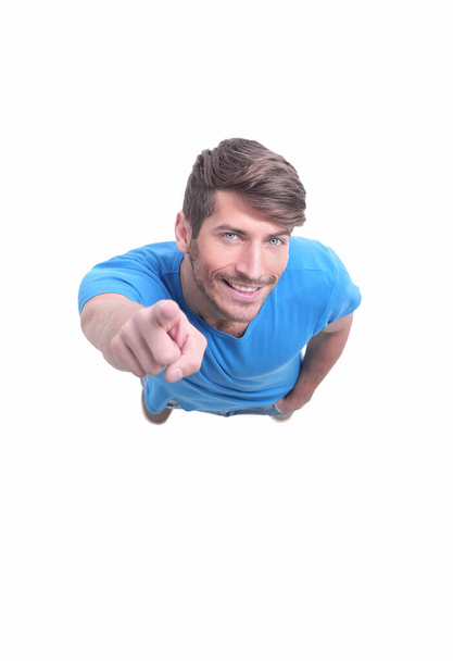 top view. smiling guy pointing at you . isolated on white - Foto, Bild