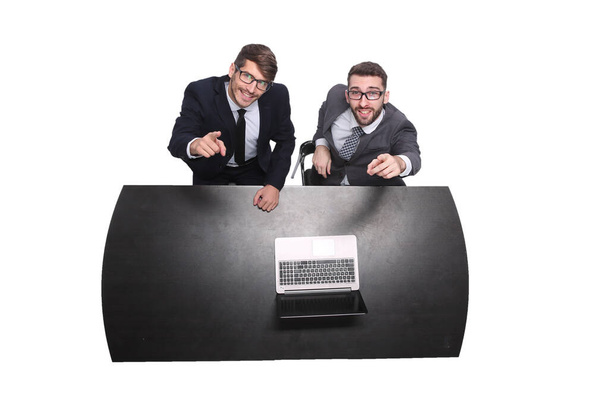 top view. smiling business colleagues sitting in front of an open laptop - Фото, изображение
