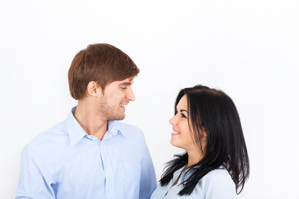 Couple smile at white wall with copy space - Foto, Imagen