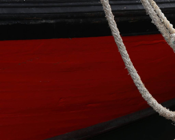A red ship with a white knot standing at the harbor - Fotoğraf, Görsel