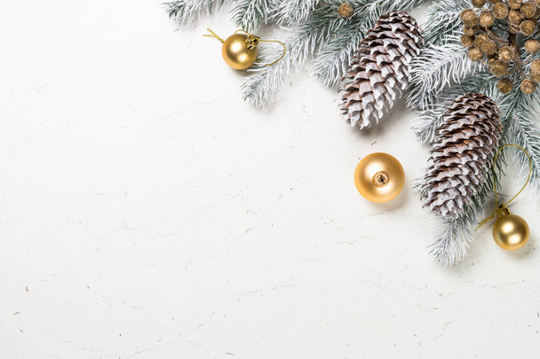 Christmas background with fir tree and decorations on white. - Φωτογραφία, εικόνα