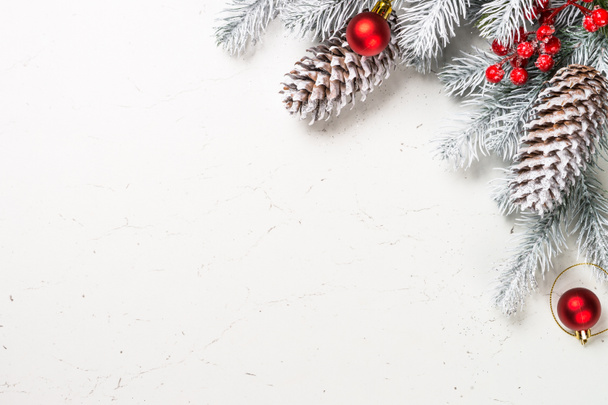 Christmas background with fir tree and decorations on white. - Foto, afbeelding