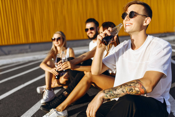 Un grupo de jóvenes amigos divirtiéndose y pasando el rato sentados en t
 - Foto, imagen