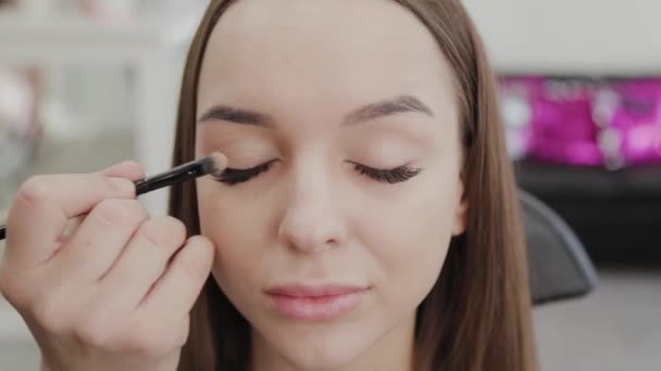 Επαγγελματική makeup artist γυναίκα αναδεύει κρέμα μακιγιάζ σε μια παλέτα. - Πλάνα, βίντεο