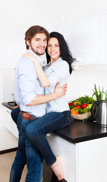 Couple at their kitchen - Фото, изображение