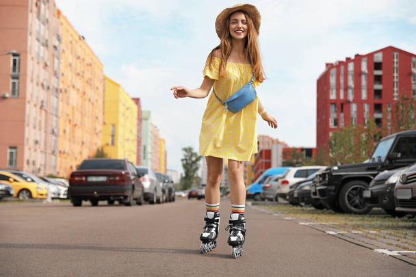 Beautiful young woman with roller skates having fun outdoors - Fotoğraf, Görsel