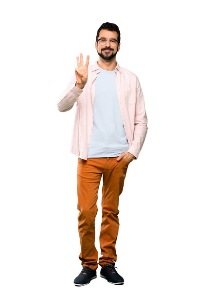 Full-length shot of Handsome man with beard happy and counting three with fingers over isolated white background - Foto, Imagen