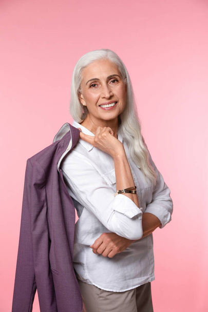 Portrait of beautiful mature woman on pink background - Foto, afbeelding