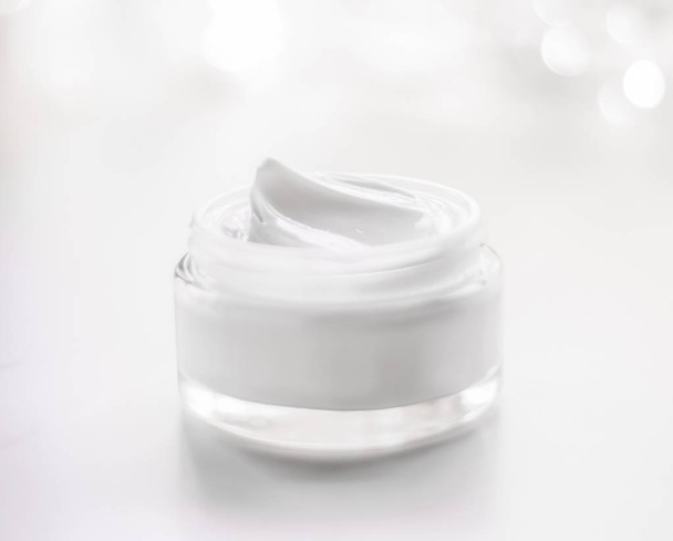 Facial cream moisturizer jar on holiday glitter background, mois - Photo, Image