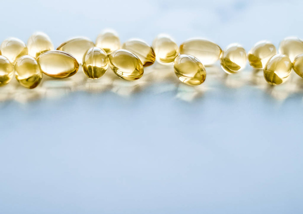 Vitamin D and golden Omega 3 pills for healthy diet nutrition, f - Fotografie, Obrázek