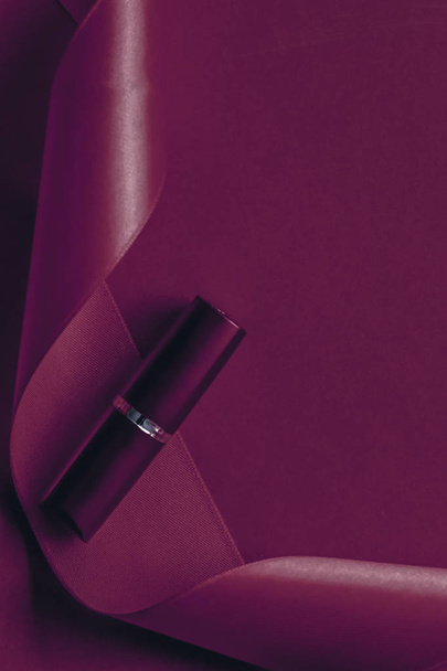 Luxury lipstick and silk ribbon on plum holiday background, make - Foto, Imagen