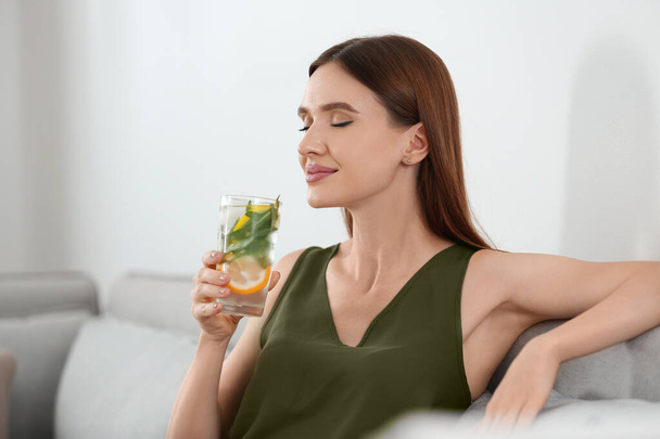 Young woman with lemonade at home. Refreshing drink - Valokuva, kuva