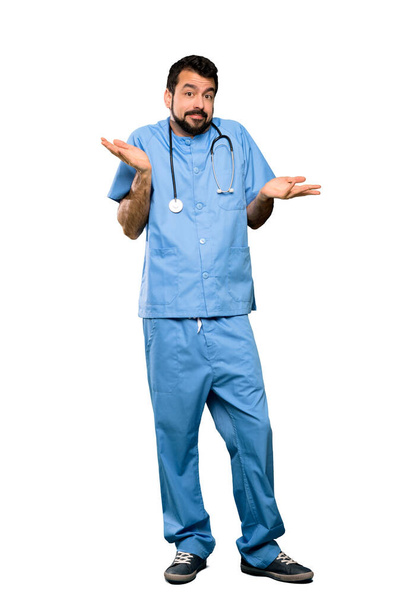 Full-length shot of Surgeon doctor man making doubts gesture over isolated white background - Foto, Bild