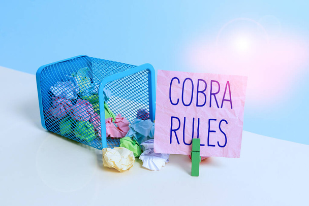 Conceptual hand writing showing Cobra Rules. Business photo text continuing group health insurance coverage after a job loss Trash bin crumpled paper clothespin reminder office supplies. - Fotoğraf, Görsel