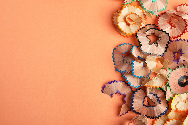Pencil shavings on orange background, top view. Space for text - Фото, зображення
