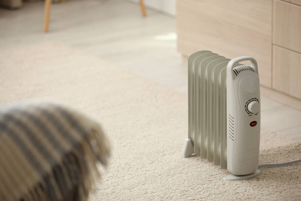 Modern electric heater on floor at home - Фото, зображення