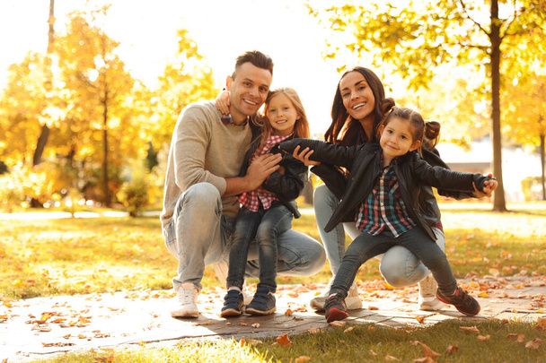Happy family with little children in sunny park. Autumn walk - Zdjęcie, obraz
