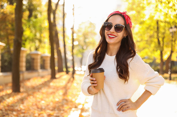 Beautiful woman with cup of coffee in park. Autumn walk - Φωτογραφία, εικόνα