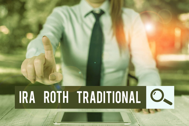 Handwriting text writing Ira Roth Traditional. Concept meaning are tax deductible on both state and federal Female business person sitting by table and holding mobile phone. - Photo, Image