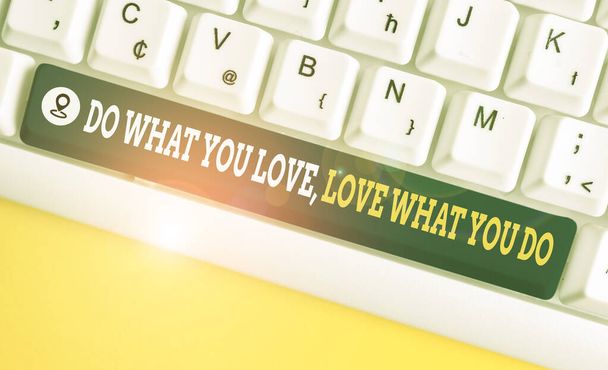 Writing note showing Do What You Love Love What You Do. Business photo showcasing you able doing stuff you enjoy it to work in better places then White pc keyboard with note paper above the white back - Foto, afbeelding
