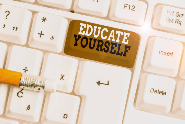 Text sign showing Educate Yourself. Conceptual photo prepare oneself or someone in a particular area or subject White pc keyboard with empty note paper above white background key copy space. - Photo, Image