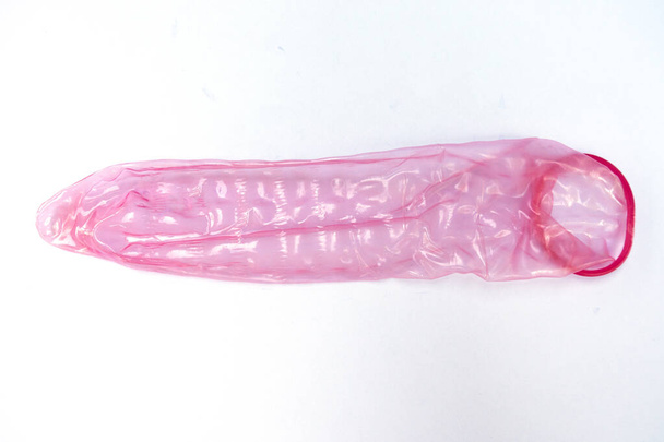 Condom είναι διαθέσιμο σε λευκό φόντο. - Φωτογραφία, εικόνα