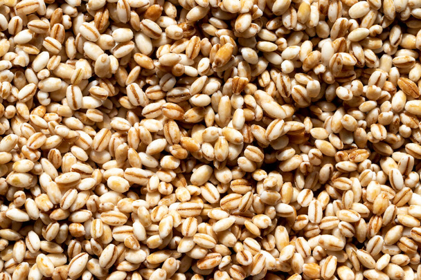Barley grains background or texture. Healthy vegeterian food. - Foto, immagini